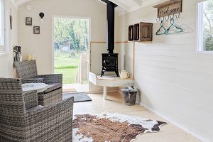 Glamping shepherd hut with wood burner at Back of Beyond Touring Park